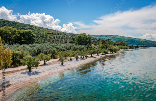 Fototapeta Naklejka Na Ścianę i Meble -  Razi beach: A picturesque small beach between Lefokastro and Afissos, in northwest Pelion, Greece.  Crystal clear water, tamarisk and olive trees.