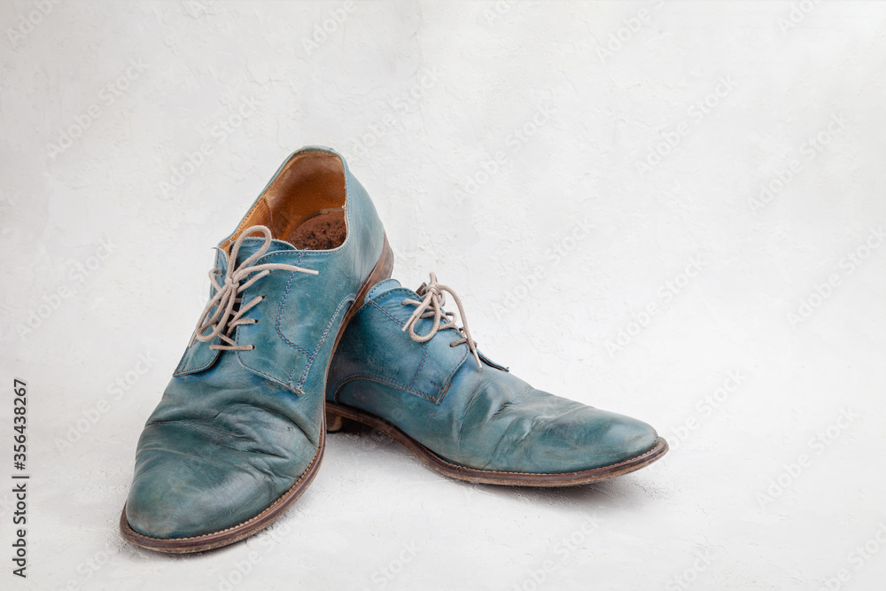 Pair of old leather blue discarded boots with laces Pair of old leather blue discarded boots with laces