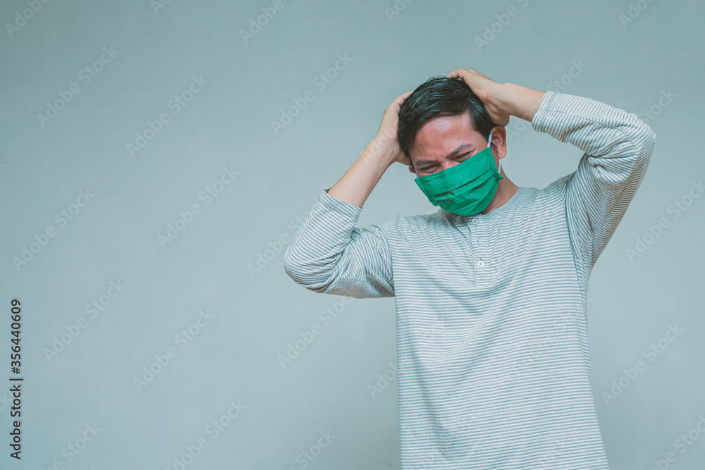 A man wearing a mask wearing a headache A man wearing a mask wearing a headache