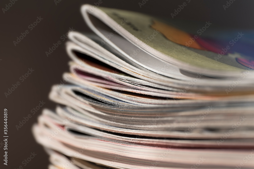 Stack of magazines on black background with narrow depth of field. Black background Stack of magazines on black background with narrow depth of field. Black background
