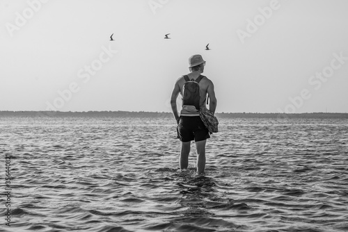 Lonly man on water with birds