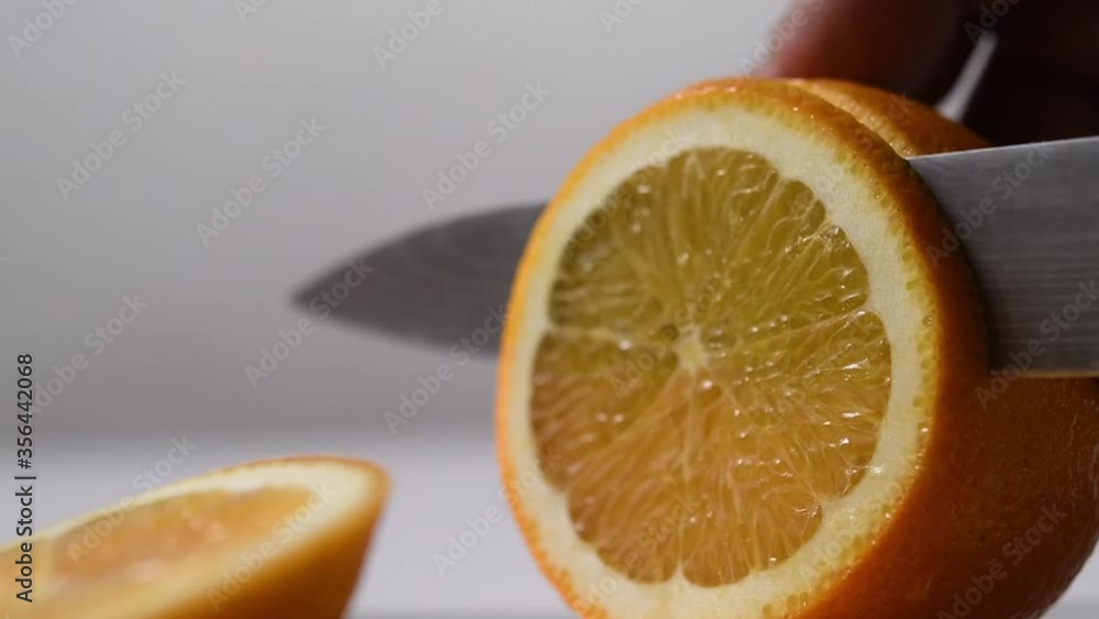 Orange slicing closeup, slow motion. Orange slicing closeup, slow motion.