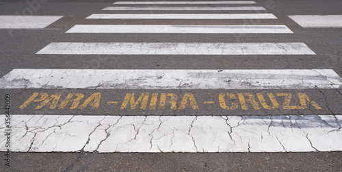 Photography zebra crossing with warning in Spanish