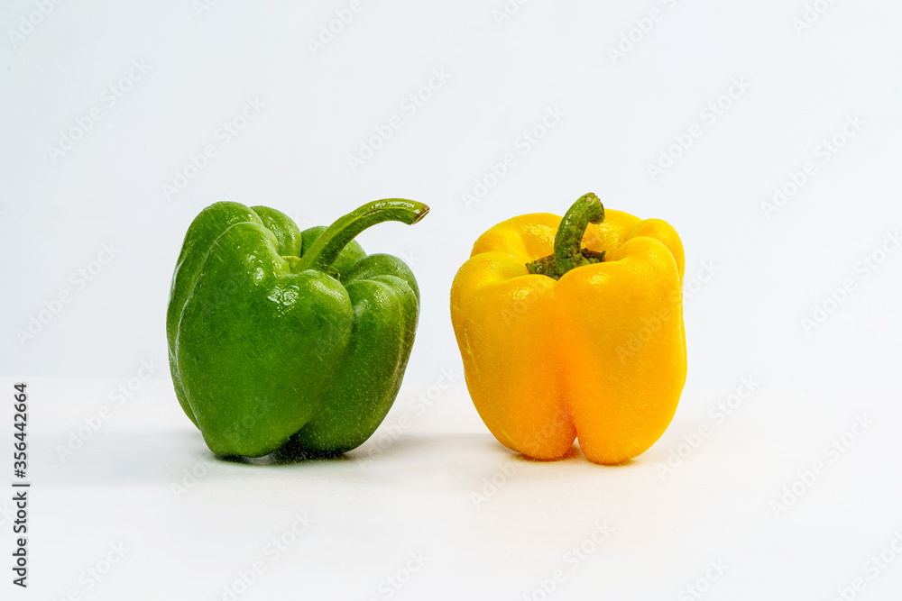 Yellow and Green Bell Pepper Wet from Water Drop on Isolated White Background. Yellow and Green Bell Pepper Wet from Water Drop on Isolated White Background.