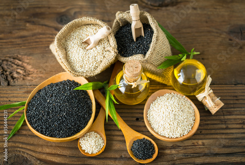 Black and white sesame seed and seseme oil on the wooden table photo