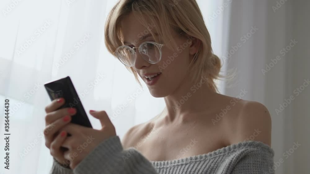 Cheerful woman using mobile messenger app, having fun communicating with friends Cheerful woman using mobile messenger app, having fun communicating with friends