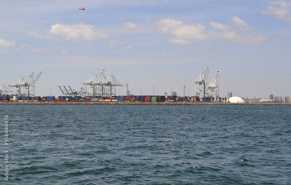 Long Beach shipping and container port with cranes loading cargo, USA
