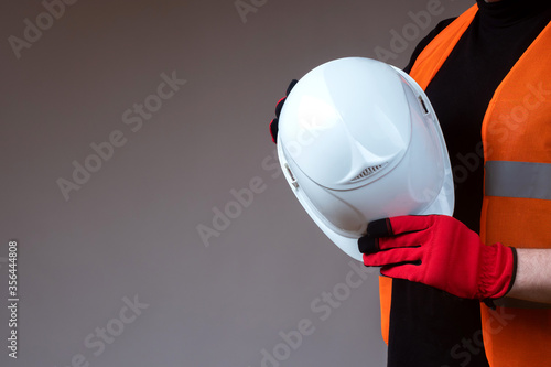 White helmet in hands of a ...