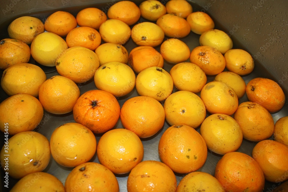 Fresh oranges under cool water