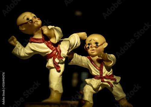 Toys playing karate in the darkness
