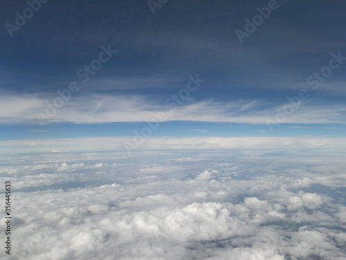 Fototapeta Naklejka Na Ścianę i Meble -  Blue sky above the clouds, lots of cumulus clouds.