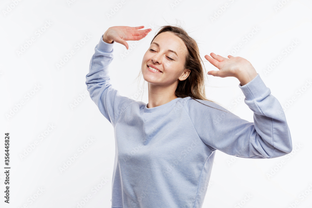 Laughing young girl in a blue t-shirt. Happiness and joy. White background. Space for text. Laughing young girl in a blue t-shirt. Happiness and joy. White background. Space for text.