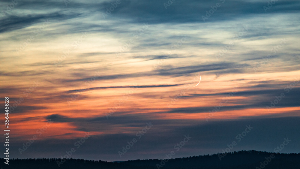 sunset in the clouds with moon