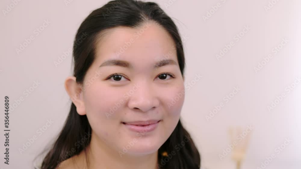 Asian women beautiful and smiling are extremely confident young face looking at camera posing alone professional portrait on holiday time and relax with clear light, scene of slow motion.4K 23.97fps Asian women beautiful and smiling are extremely confident young face looking at camera posing alone professional portrait on holiday time and relax with clear light, scene of slow motion.4K 23.97fps