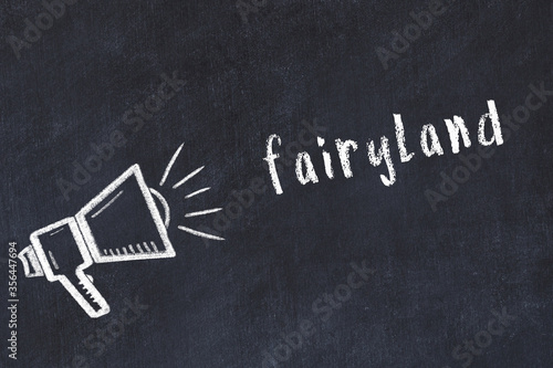 Fotografie Chalk loudspeaker and inscription fairyland on black chalkboard
