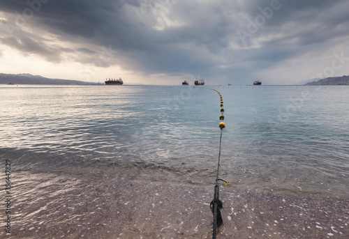 Line of plastic buoys on central public beach of Eilat, Red Sea, Israel