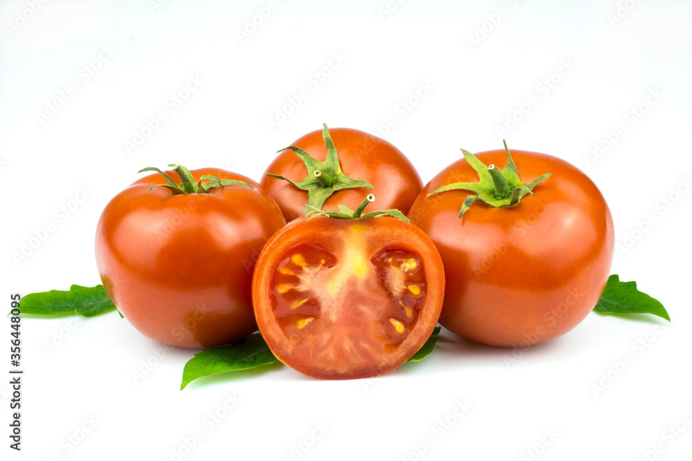 Fresh tomatoes with green leaves isolated on a white background. Fresh tomatoes with green leaves isolated on a white background.