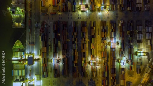 Aerial view drone time-lapse or hyper-lapse over industrial port in Bangkok Thailand with many container vessel ship.