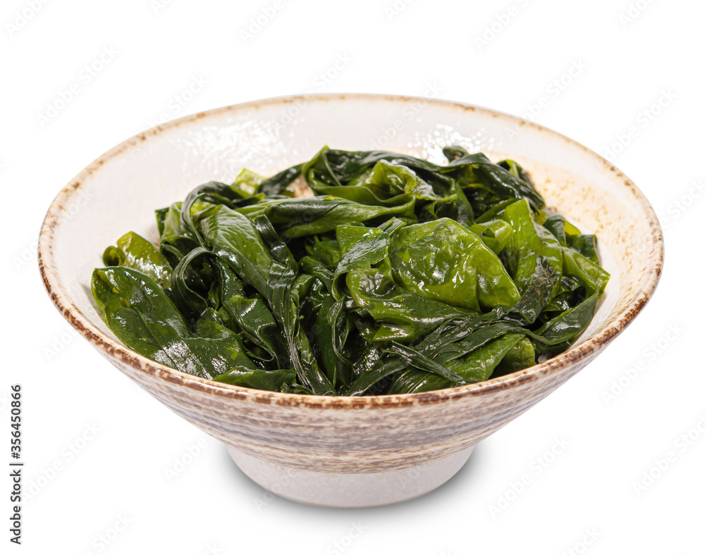Laminaria (Kelp) seaweed in bowl Isolated on white background. miyeok muchim. korean seaweed salad Laminaria (Kelp) seaweed in bowl Isolated on white background. miyeok muchim. korean seaweed salad