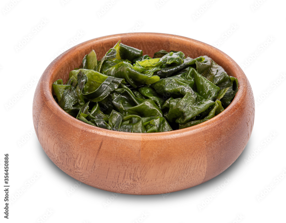 Laminaria (Kelp) Seaweed in wooden bowl Isolated on White Background. miyeok muchim. korean Seaweed Salad Laminaria (Kelp) Seaweed in wooden bowl Isolated on White Background. miyeok muchim. korean Seaweed Salad