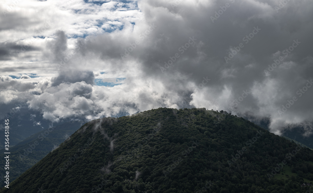 Mysterious black mountain with dramatic cloudy sky
