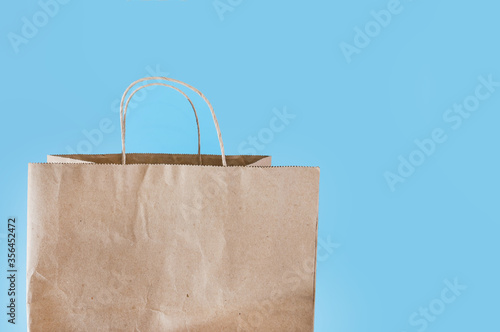 Paper takeaway bag isolated on dark blue background. Packaging template mock up. Close-up. Copy of space.