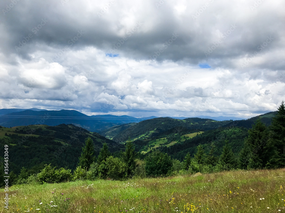 Ukrainian mountains Karpaty with cloudy sky and green trees Ukrainian mountains Karpaty with cloudy sky and green trees