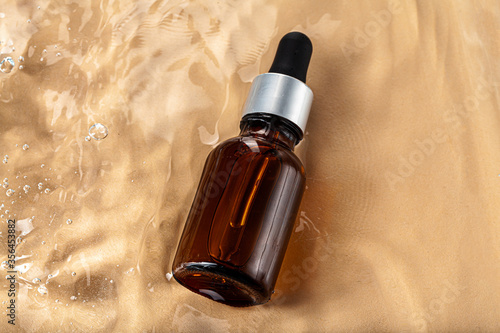 Cosmetic bottle with pipette in wavy water