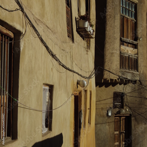 the old yellow house and wooden door and windows at Masuleh Iran.the old house of iran architecture. photo