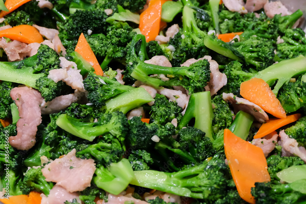 The hot stir fried broccoli, carrot with giant pork (close up) - food concept. The hot stir fried broccoli, carrot with giant pork (close up) - food concept.