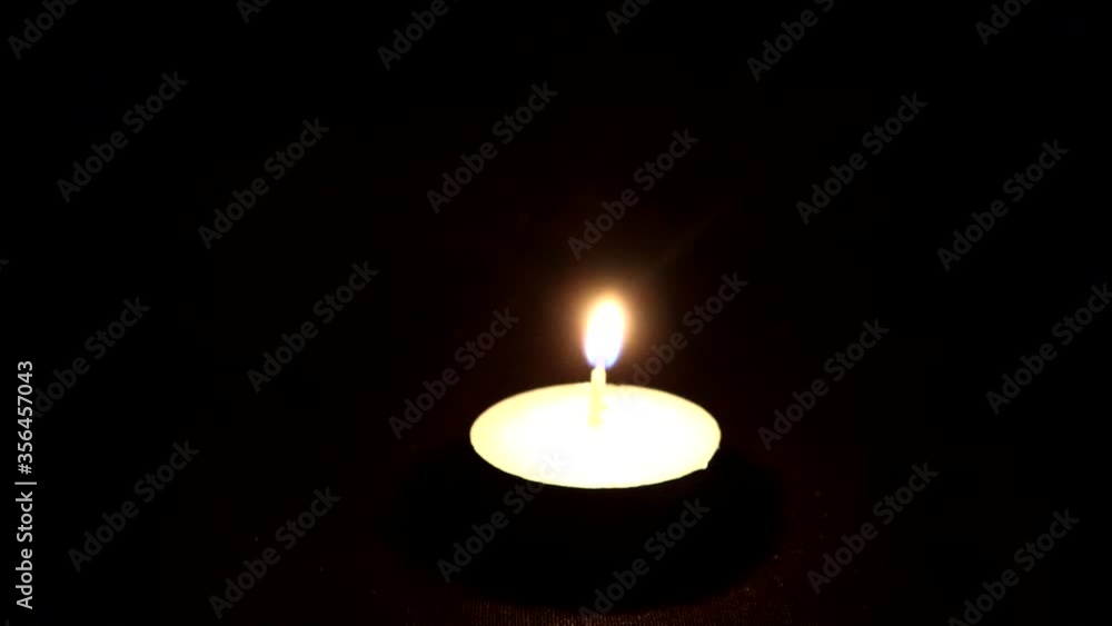 A Single Tealight candle Being Lit A Single Tealight candle Being Lit