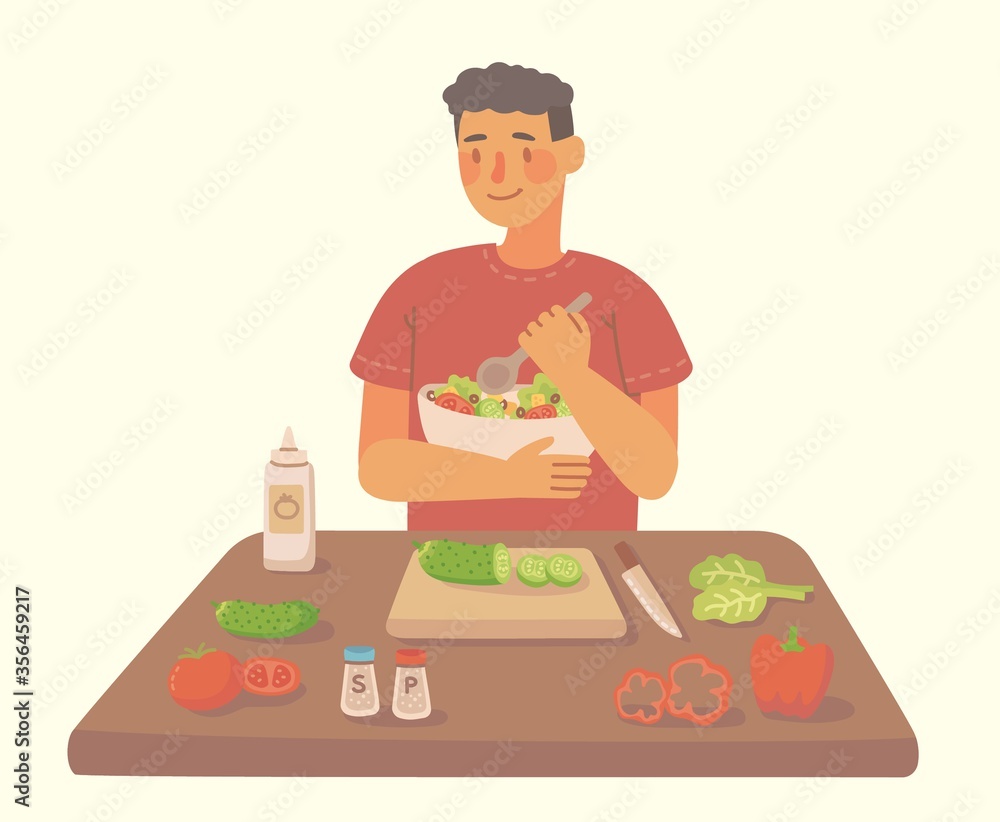 Young man cooking at a kitchen homemade salad at home. Cooking salad with ingredients. Young man cooking at a kitchen homemade salad at home. Cooking salad with ingredients.