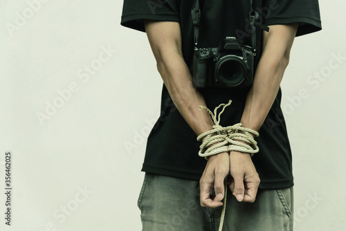 slave photographer / photographer has bundle by rope