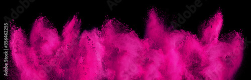 pink magenta holi paint color powder explosion isolated  dark black background. industry beautiful party festival concept