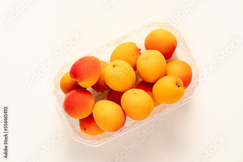 peaches in plastic packaging from a supermarket.