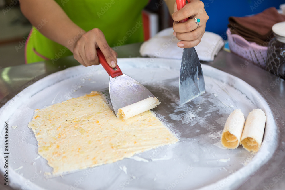 process of making fried ice-cream. Thailand stir-fried ice cream rolls at  freeze pan. Organic, natural rolled ice cream, hand made dessert. Fried ice  cream machine with steel chilled pan. Stock Photo