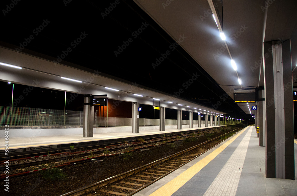 Evening shot of the train station and waiting area of passengers in Giarre, Catania , Sicily