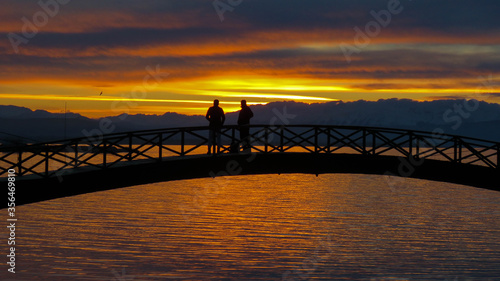 People watching the sunset on the bridge