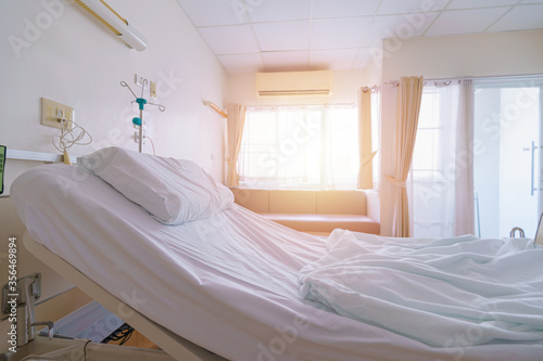 Hospital bed patient is empty. For medical healthcare of patients a ill sick person, rests placed next the window in ward waiting for new patients and doctor. Sunlight and flare background.