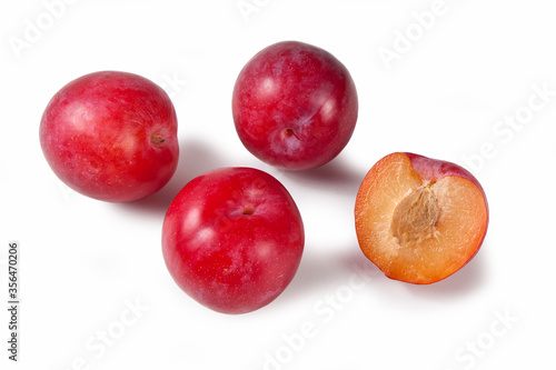 Red plum fruits isolated on white