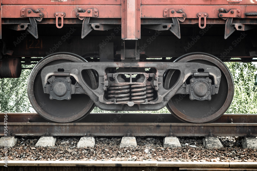 Naklejka premium Closeup of wheelset springs at the railway multiple unit. Unpowered railway vehicles that are used for the transportation of cargo.