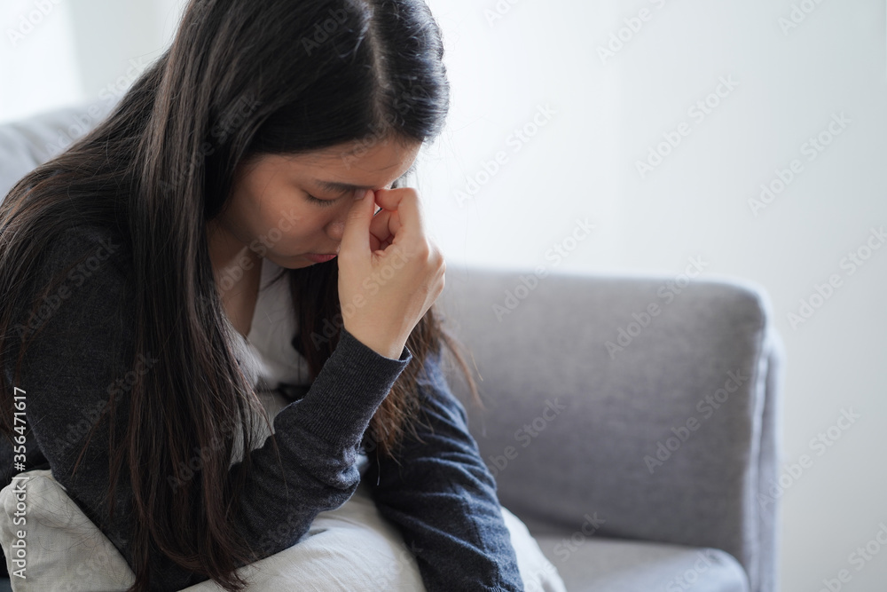 Asian depressed woman sitting alone feel stress sad and serious Asian depressed woman sitting alone feel stress sad and serious