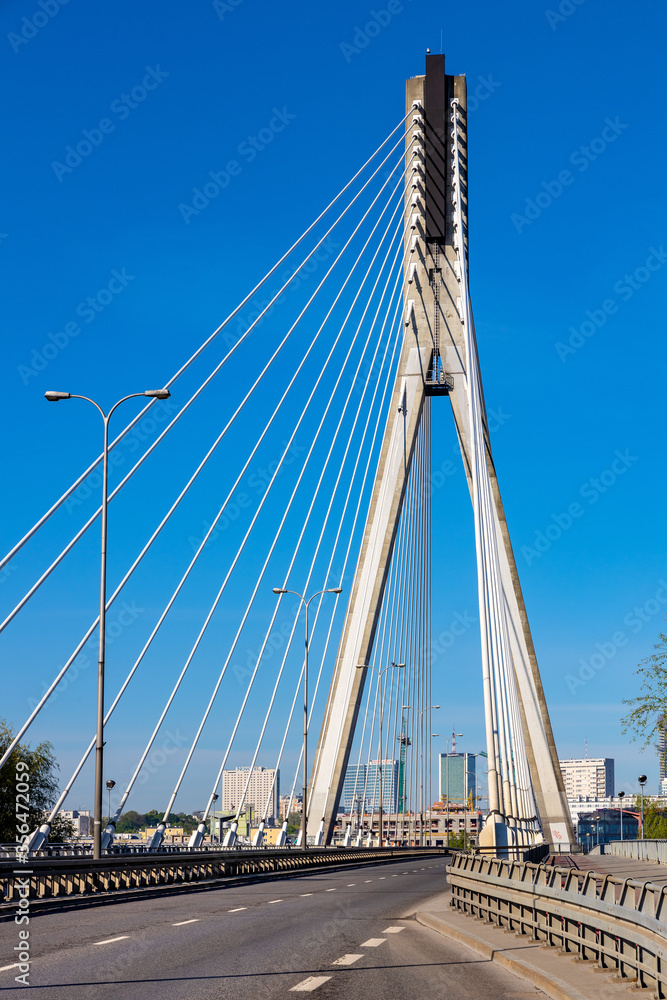 Panoramic view of Swietokrzyski Bridge - Most Swietokrzyski - with Vistula river with Srodmiescie city center of Warsaw, Poland in background