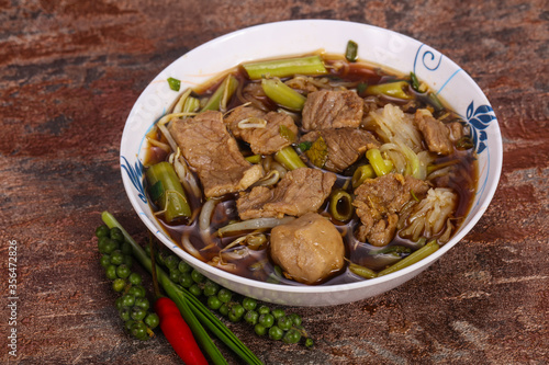 Thai style soup with meat and mushrooms