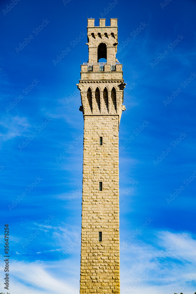 Pilgrim Monument isolated against a blue sky & Provincetown Museum. Provincetown, Massachusetts, USA. September 2019.