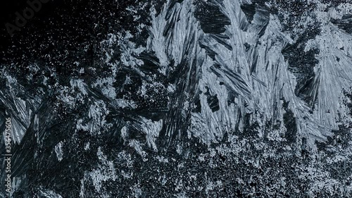 Ice Forming process 4K, Window freezing on dark background. Ice growind with dots and spikes