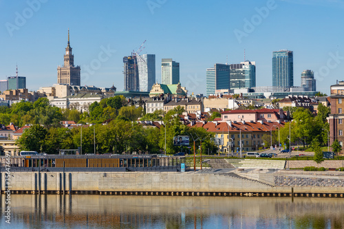 Panoramic view of Srodmiescie city center quarter and Powisle district at Wybrzeze Kosciuszkowskie embankment over Vistula river in Warsaw, Poland