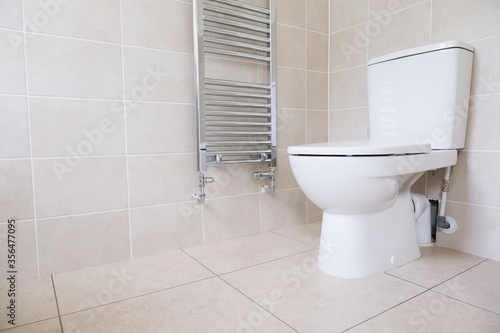 White WC toilet pan and chrome towel rail