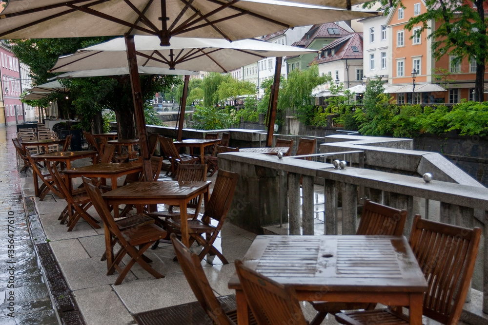summer terrace of a small cozy restaurant near the river during rains