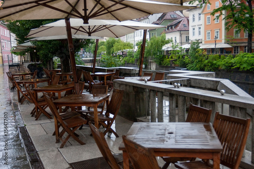 summer terrace of a small cozy restaurant near the river during rains